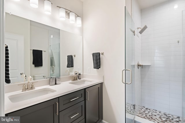 bathroom with a shower with door, vanity, and toilet