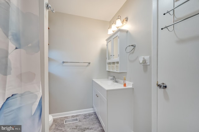 bathroom featuring vanity, toilet, and walk in shower