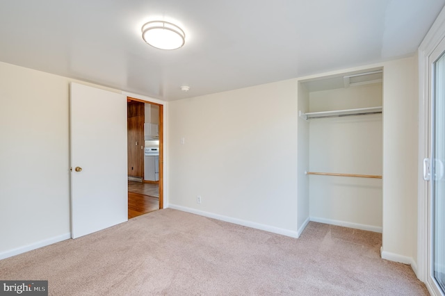 unfurnished bedroom with a closet and light carpet