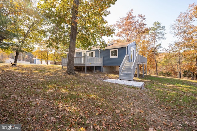 back of house featuring a wooden deck