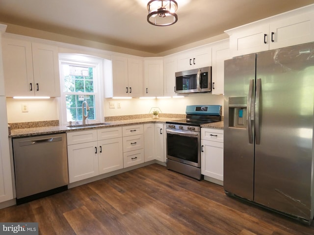 kitchen featuring sink, white cabinets, stainless steel appliances, and dark hardwood / wood-style floors