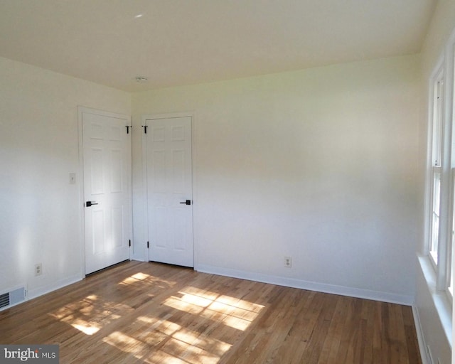 unfurnished room featuring hardwood / wood-style floors