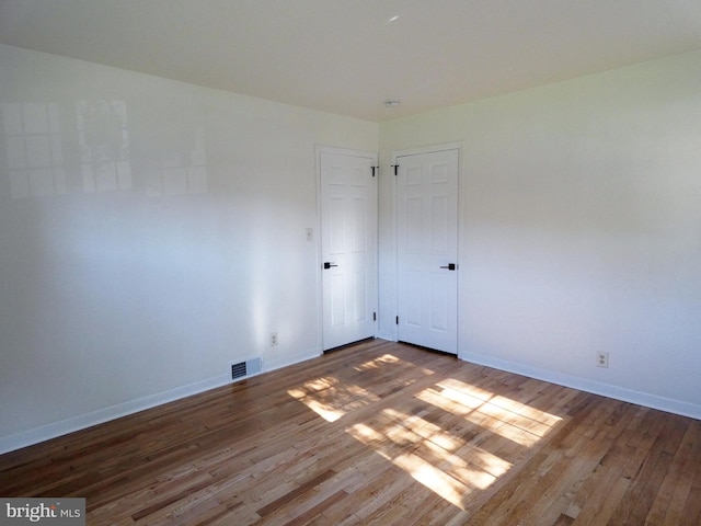 unfurnished room featuring hardwood / wood-style floors