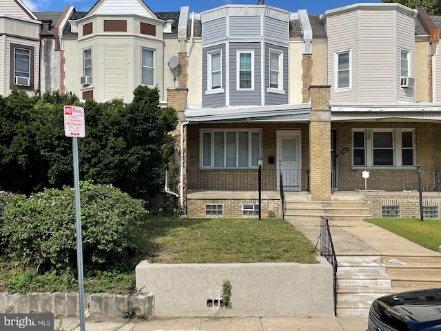 view of property with a front lawn and a porch