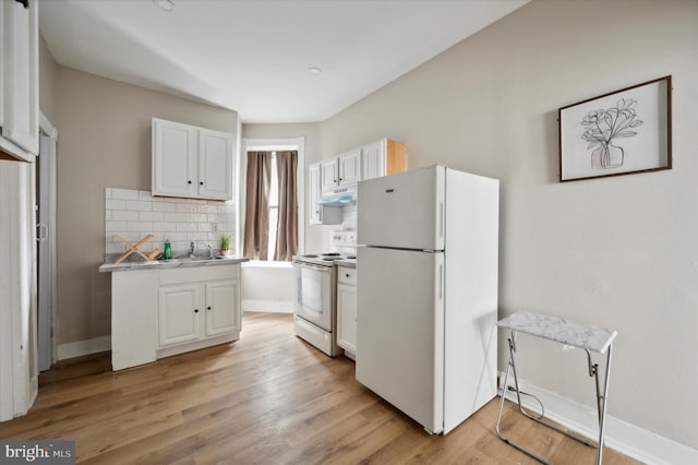 kitchen with sink, tasteful backsplash, white appliances, white cabinetry, and light wood-type flooring