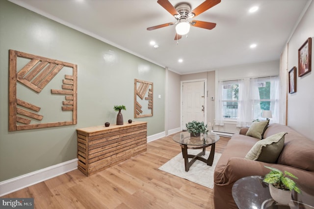 living room with ornamental molding, ceiling fan, and light hardwood / wood-style flooring