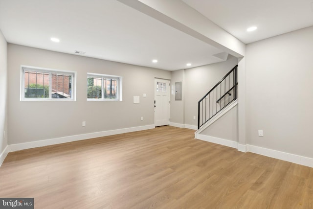 interior space featuring electric panel and light wood-type flooring