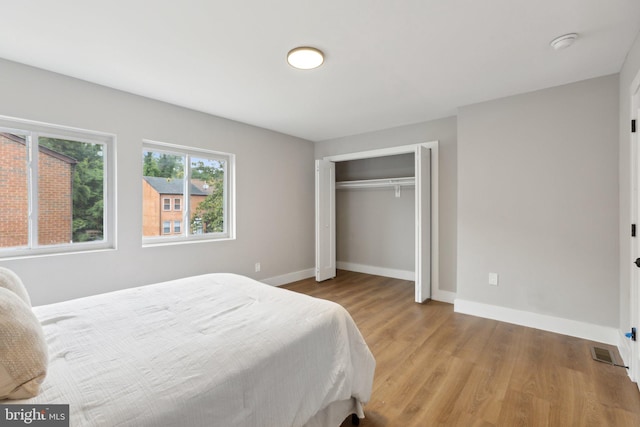 bedroom with a closet and light hardwood / wood-style floors