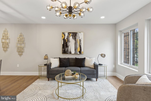 living room featuring light wood-type flooring and a chandelier