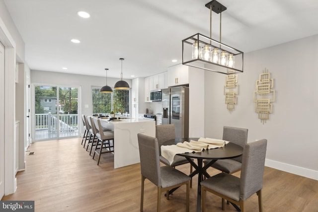 dining area featuring light wood-type flooring