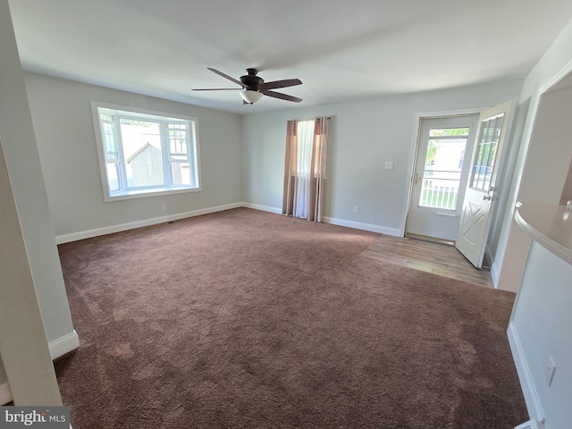 carpeted spare room featuring ceiling fan