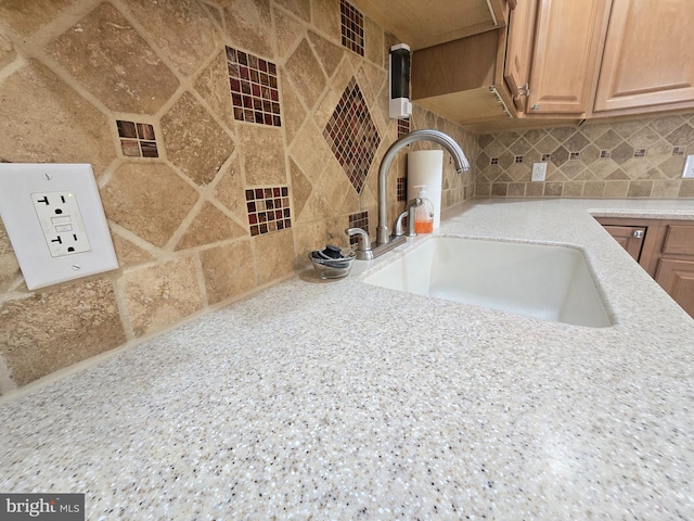 interior details featuring backsplash and sink