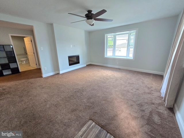 unfurnished living room featuring carpet and ceiling fan