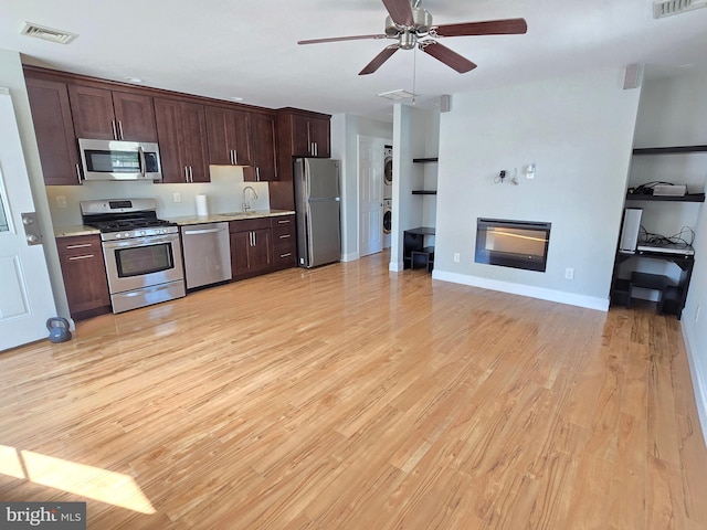 kitchen featuring light hardwood / wood-style flooring, sink, ceiling fan, dark brown cabinets, and appliances with stainless steel finishes