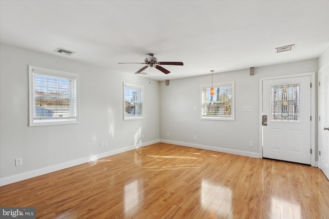 interior space featuring light wood-type flooring, ceiling fan, and plenty of natural light