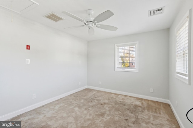 spare room featuring ceiling fan and light carpet