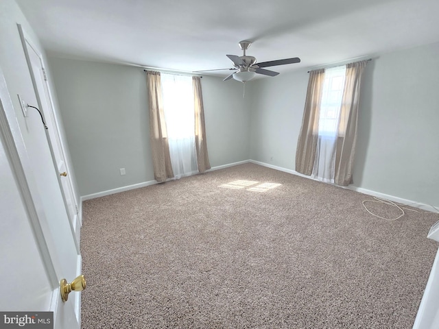 spare room featuring carpet and ceiling fan