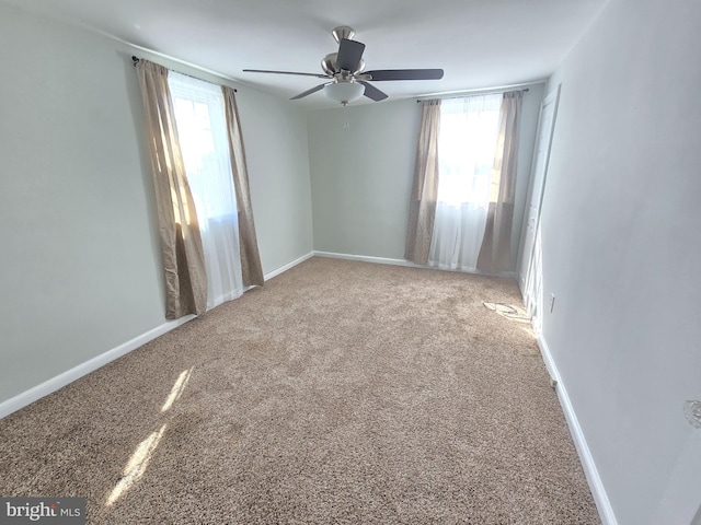 empty room featuring carpet floors and ceiling fan