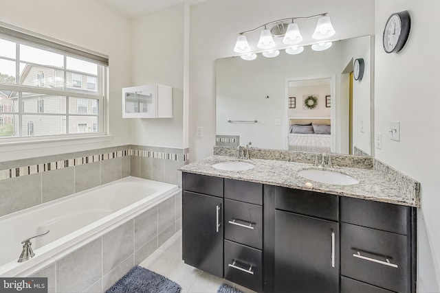 bathroom with vanity, tile patterned floors, and a relaxing tiled tub