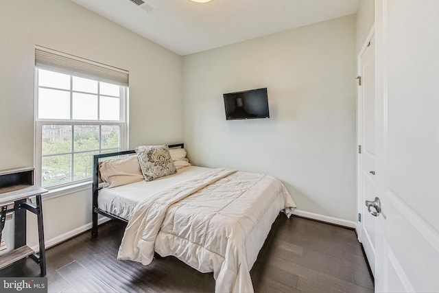 bedroom featuring dark hardwood / wood-style flooring