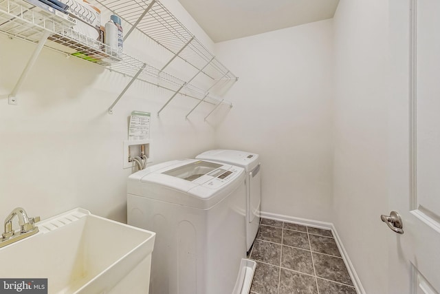 clothes washing area featuring sink and washing machine and clothes dryer