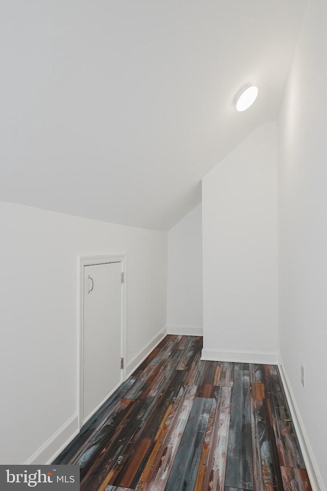 bonus room with lofted ceiling and dark hardwood / wood-style floors