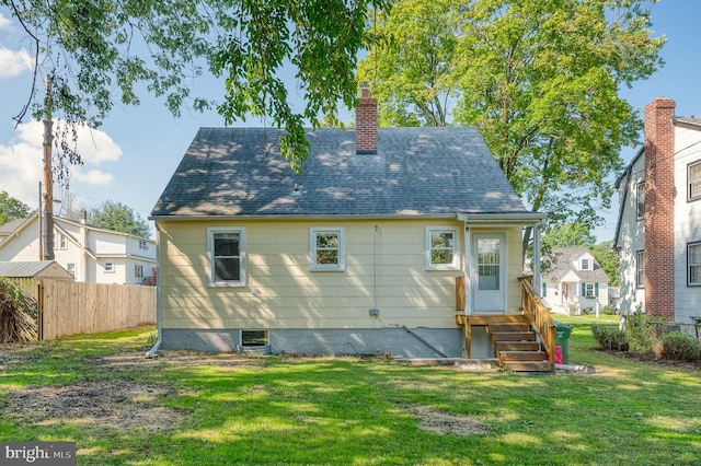 rear view of house with a lawn