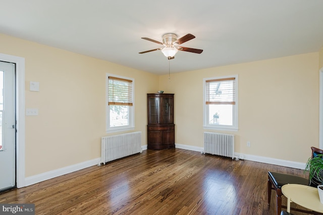 interior space with radiator, dark hardwood / wood-style floors, and ceiling fan