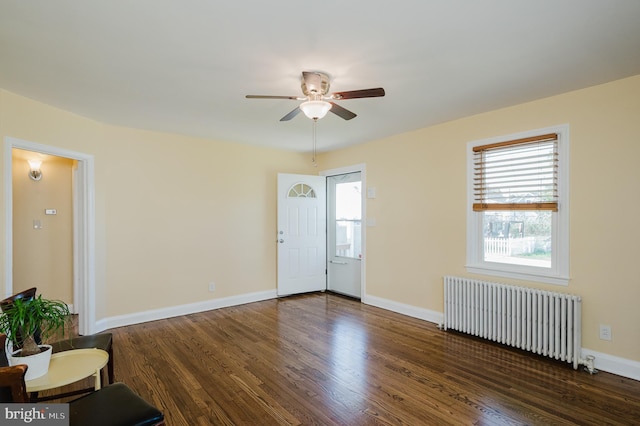 entrance foyer with radiator, ceiling fan, and dark wood-type flooring