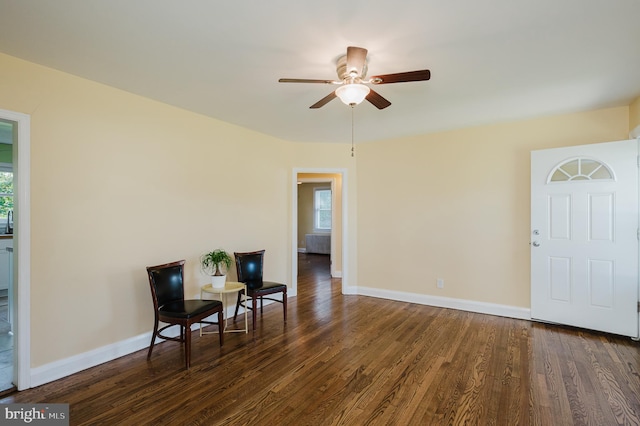 sitting room featuring dark hardwood / wood-style flooring, ceiling fan, and a wealth of natural light