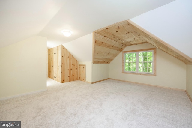 bonus room with light carpet and lofted ceiling