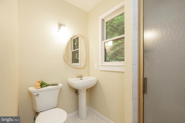 bathroom with walk in shower and toilet