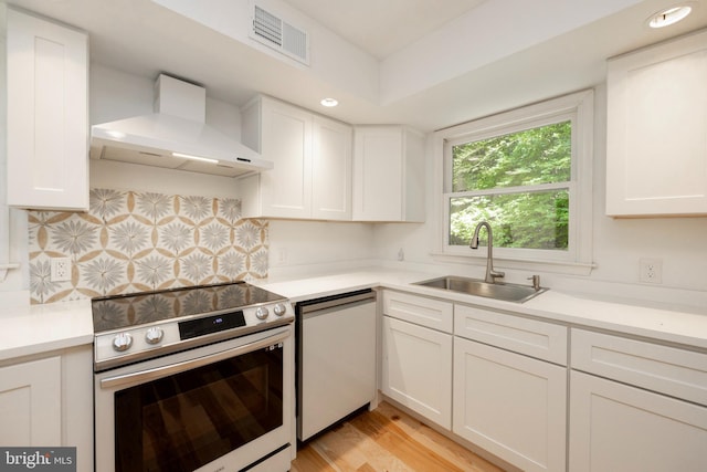 kitchen with dishwasher, sink, electric stove, white cabinetry, and exhaust hood