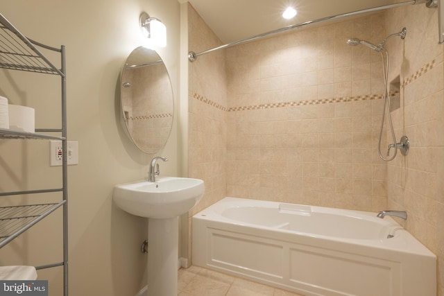 bathroom featuring tiled shower / bath, tile patterned floors, and sink