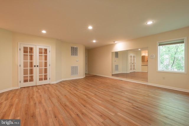 empty room featuring light wood-type flooring and french doors