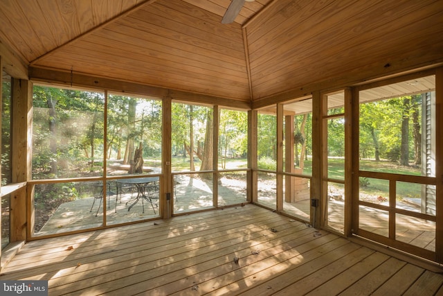 unfurnished sunroom with wood ceiling, lofted ceiling, and a healthy amount of sunlight