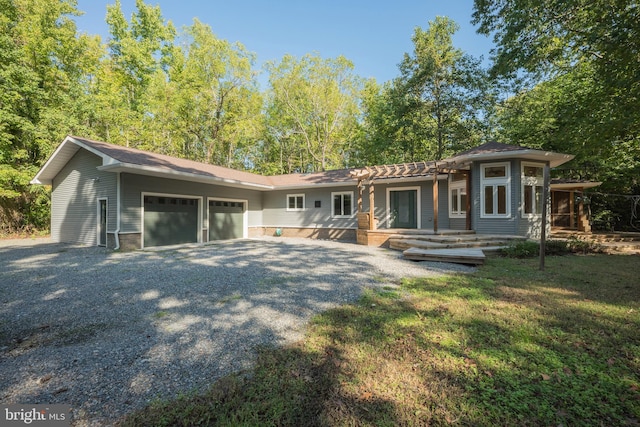 back of property featuring a yard and a garage