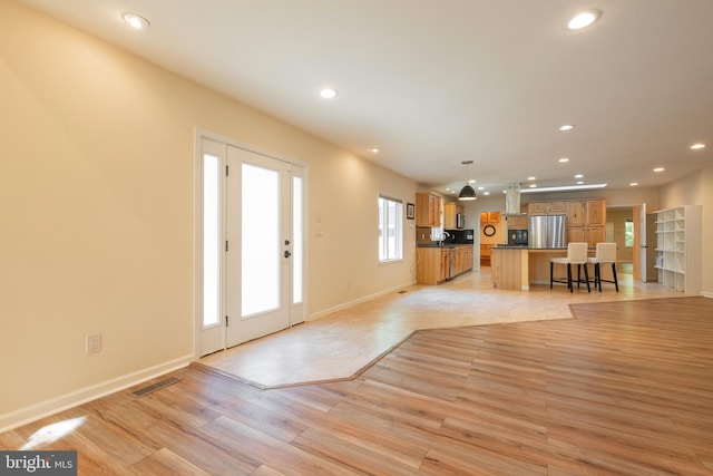 unfurnished living room featuring light wood-type flooring