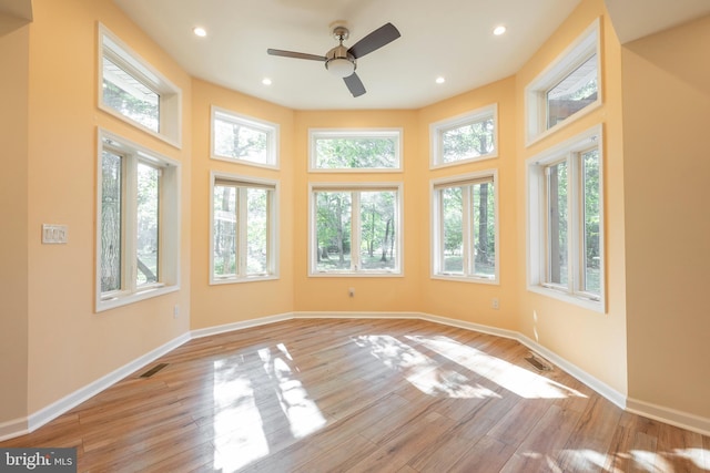 interior space featuring a high ceiling, light hardwood / wood-style floors, and ceiling fan