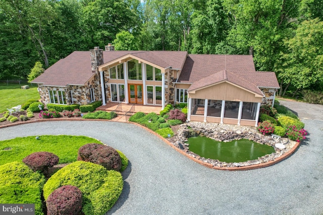 view of front facade with a sunroom