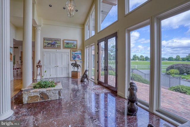 interior space featuring french doors and ornate columns