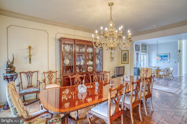 dining space with crown molding, a chandelier, and parquet floors