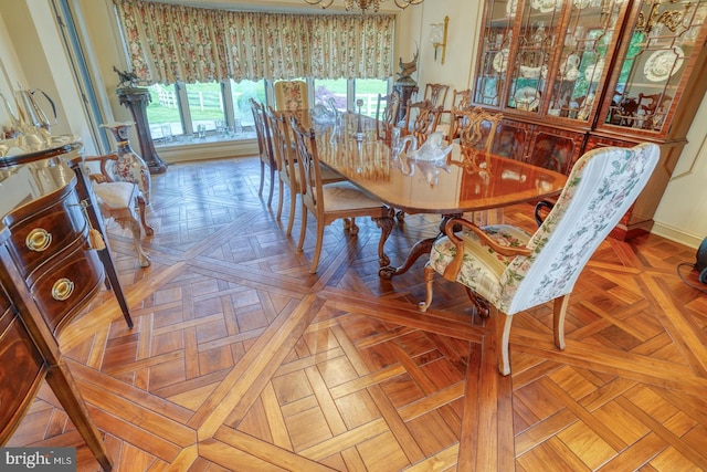 dining room featuring parquet floors