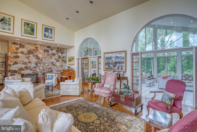 living room featuring hardwood / wood-style flooring and high vaulted ceiling