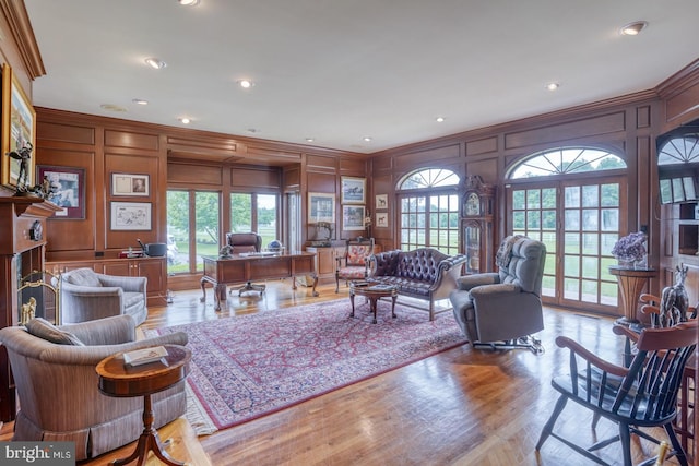 living room featuring wood-type flooring and crown molding