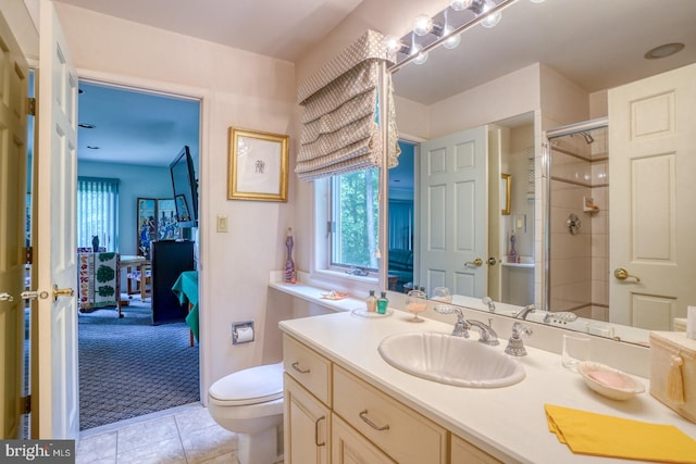 bathroom with an enclosed shower, tile patterned floors, vanity, and toilet