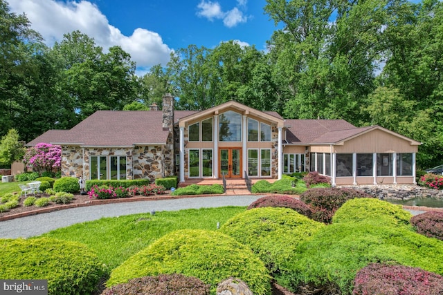 rear view of property with a sunroom