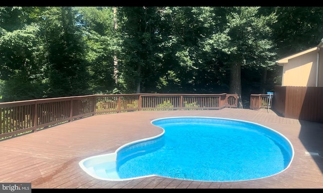 view of swimming pool with a deck