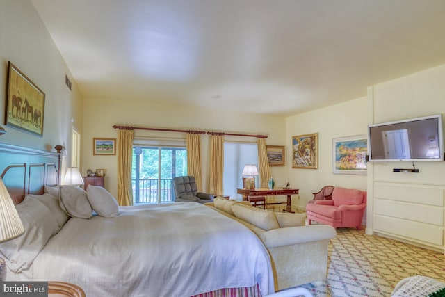 bedroom featuring access to exterior and light carpet