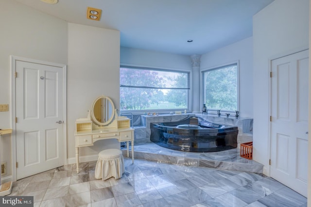 bathroom featuring tiled bath